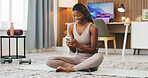 Fitness, woman and smile in living room with phone, exercise mat and notification for wellness app. Happy, black person and scroll in house with tech, online guide or search site for pilates workout.