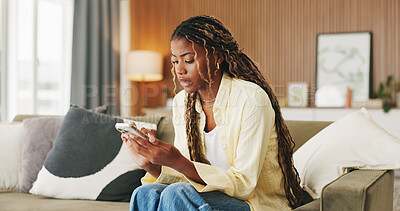 Buy stock photo Worry, reading and phone with black woman on sofa in home for communication, mistake and scam. Contact, online glitch and phishing link with person and mobile in living room of apartment for app