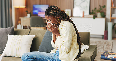 Buy stock photo Sneeze, tissue and black woman on couch, sick and cold with fever in living room. Unhappy, illness and African person in home, allergy and recover for infection, blowing nose and influenza symptoms