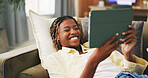 Happy, home and black woman on sofa, tablet for social media and reaction for post. Apartment, tech and African person on couch, connection for online announcement, internet and smile for text