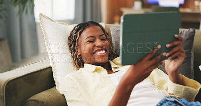 Buy stock photo Happy, home and black woman on sofa, tablet for social media and reaction for post. Apartment, tech and African person on couch, connection for online announcement, internet and smile for text