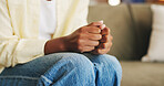 Anxiety, worry and hands of woman on sofa for overthinking, unsure and nervous for mental health. Home, therapy and person with gesture for anxious, overwhelmed and stress in living room for trauma