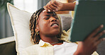 Black woman, tablet and stress with headache on sofa in home with burnout, vertigo and tired in lounge. African person, tech and migraine on couch with application, break or frustrated at house