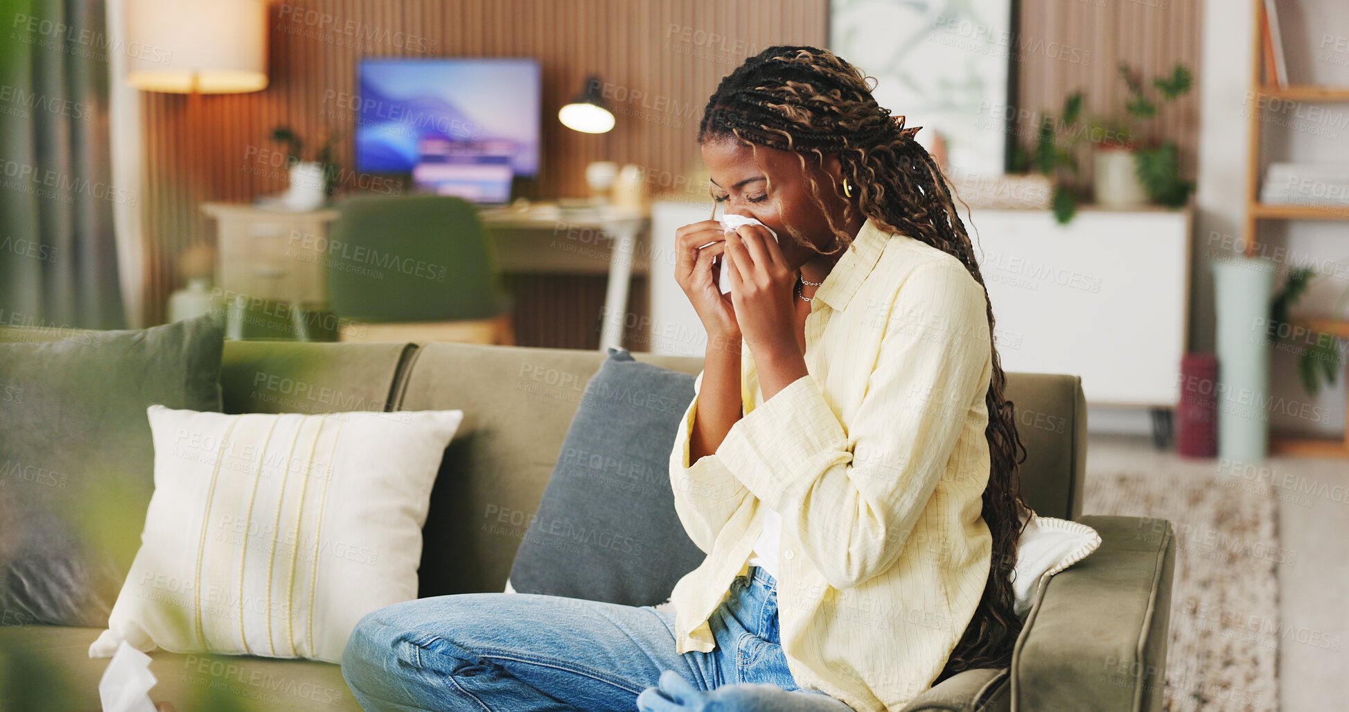 Buy stock photo Sneeze, tissue and black woman in home, virus and cold with fever in living room. Allergy, illness and African person on couch, sick and recover for infection, blowing nose and influenza symptoms