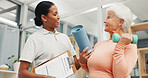 Old woman, physiotherapist and happy with dumbbell at clinic for discussion, recovery and exercise. Elderly person, smile and medical professional with clipboard, report or service for rehabilitation