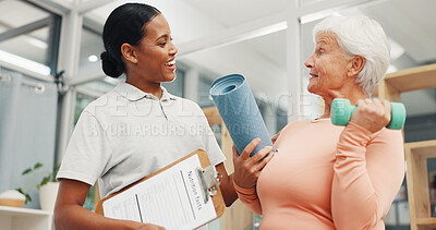 Buy stock photo Old woman, physiotherapist and happy with dumbbell at clinic for discussion, recovery and exercise. Elderly person, smile and medical professional with clipboard, report or service for rehabilitation