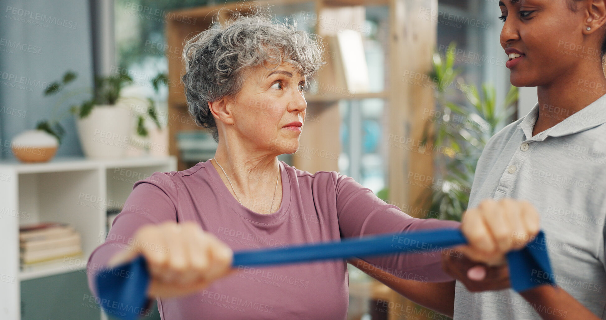 Buy stock photo Old woman, physiotherapist and resistance band at clinic with talk, rehabilitation or muscle wellness. People, smile and guide with stretching arms for injury, exercise or support in retirement