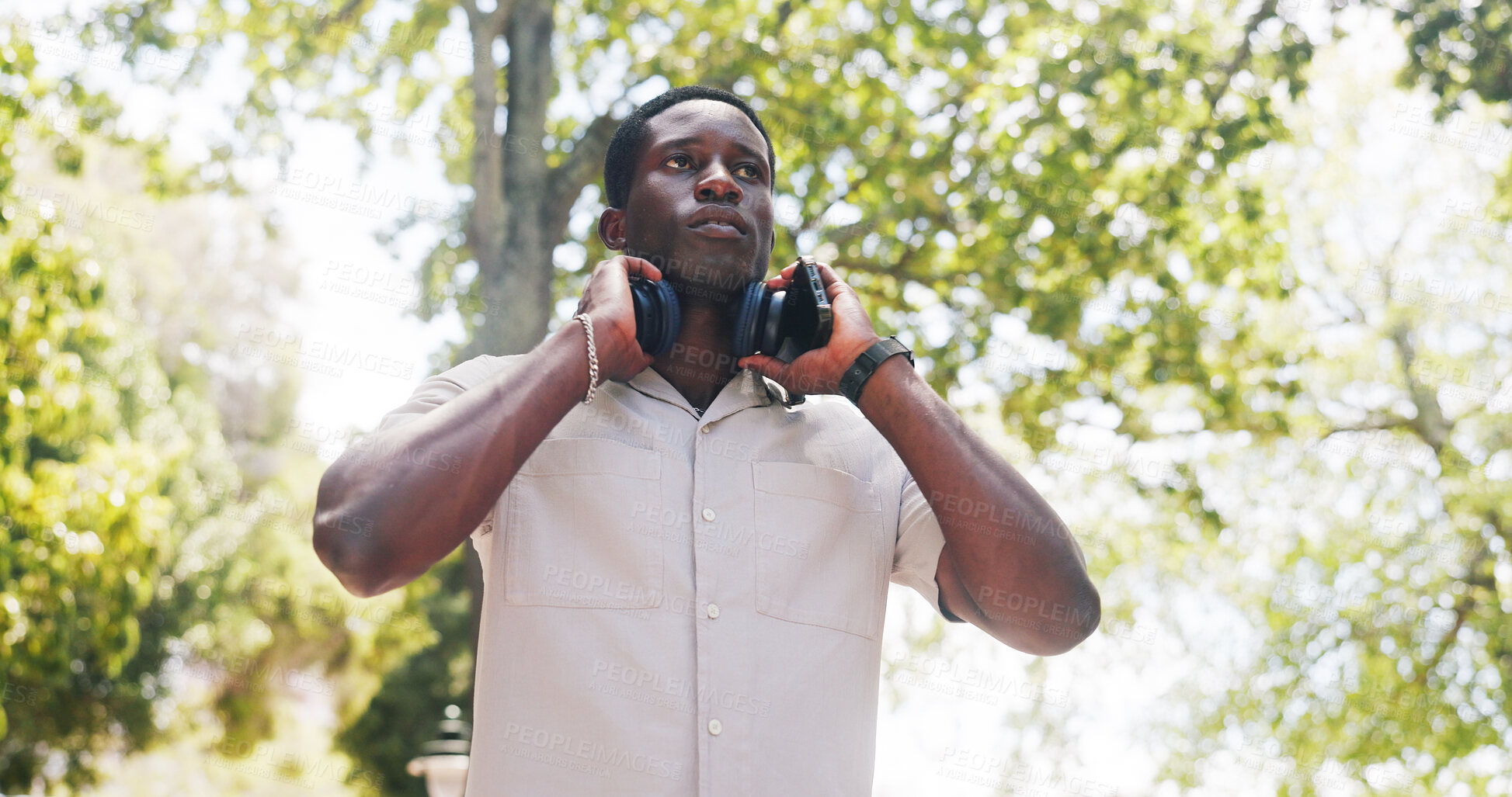 Buy stock photo Black man, thinking and tourist at park with headphones, streaming or phone for music on commute in summer. African person, perspective and reflection with sound, audio and subscription in nature