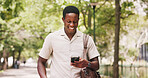 Park, phone and businessman with smile for commute, online communication or check social media. Reading, message app or black person outdoor with mobile for networking, review email or morning travel