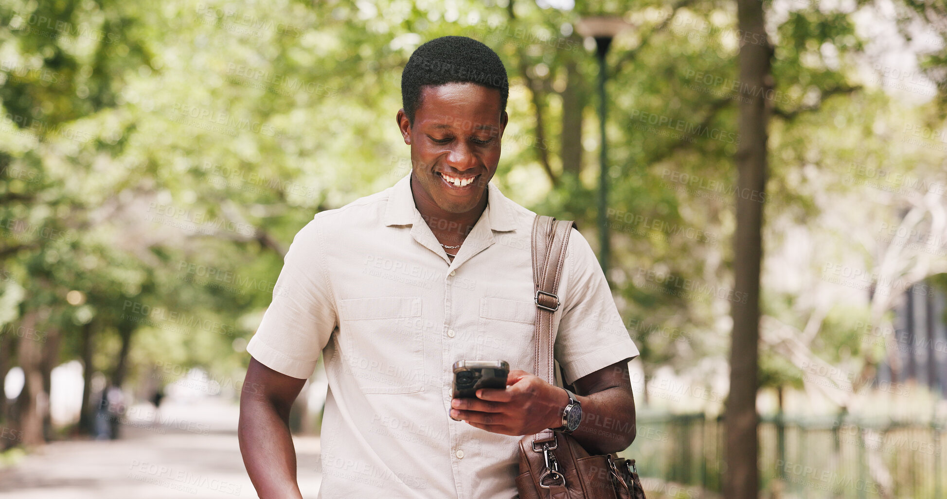 Buy stock photo Park, phone and businessman with smile for commute, online communication or check social media. Reading, message app or black person outdoor with mobile for networking, review email or morning travel