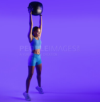 Buy stock photo Woman, fitness and medicine ball in studio with workout, stretching and mockup space on purple background. Person, balance and training with gear, intense exercise and muscle development for wellness