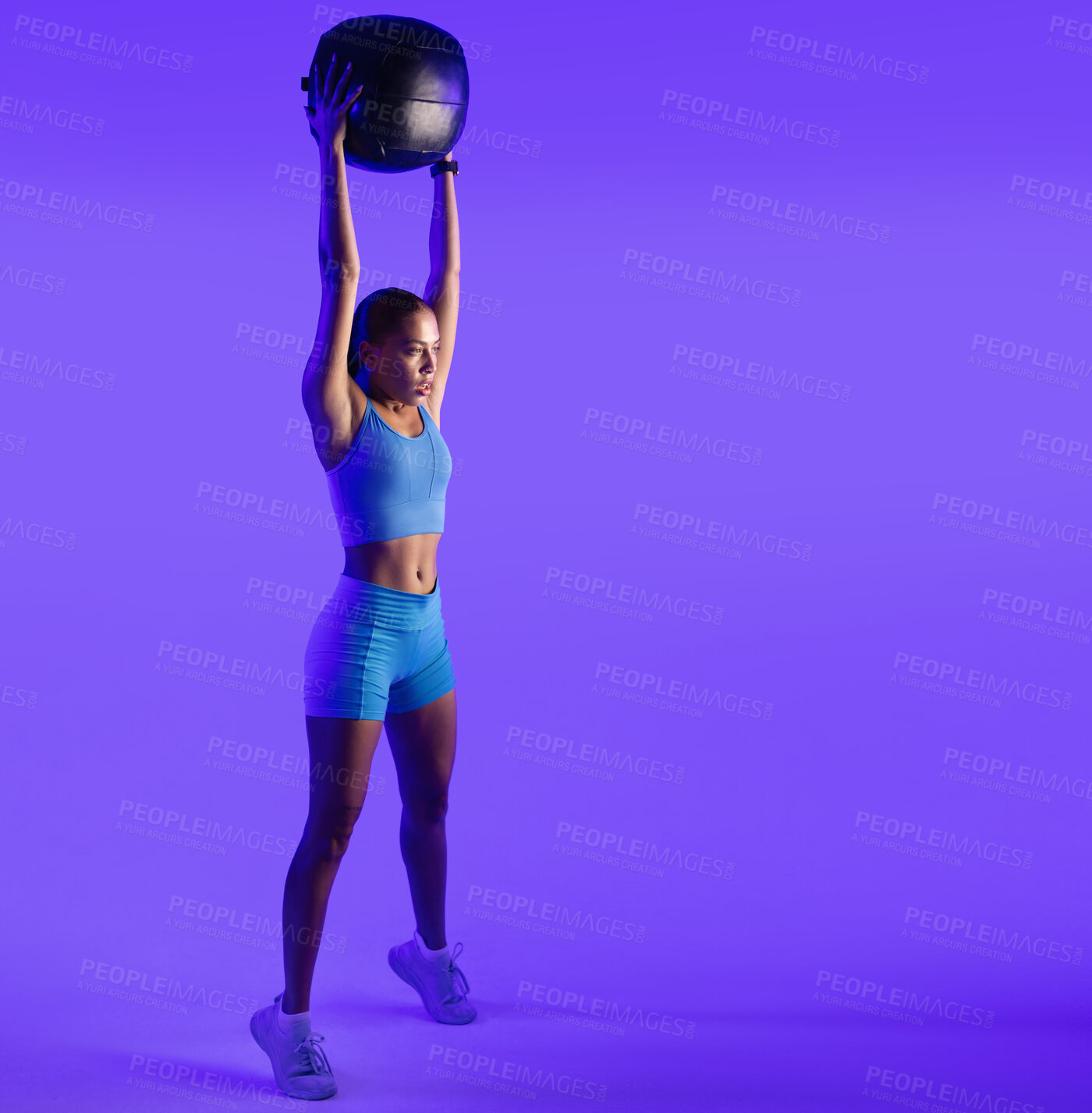 Buy stock photo Woman, fitness and medicine ball in studio with workout, stretching and mockup space on purple background. Person, balance and training with gear, intense exercise and muscle development for wellness