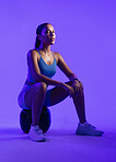 Woman, fitness and medicine ball in studio with portrait, confidence and rest on purple background. Person, balance and training with pride, exercise and muscle development for wellness in Mexico