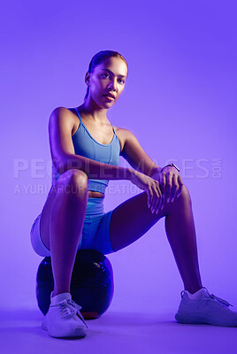 Buy stock photo Woman, exercise and medicine ball in studio with balance, serious and portrait on purple background. Person, confidence and training with pride, fitness or muscle development for wellness in Mexico