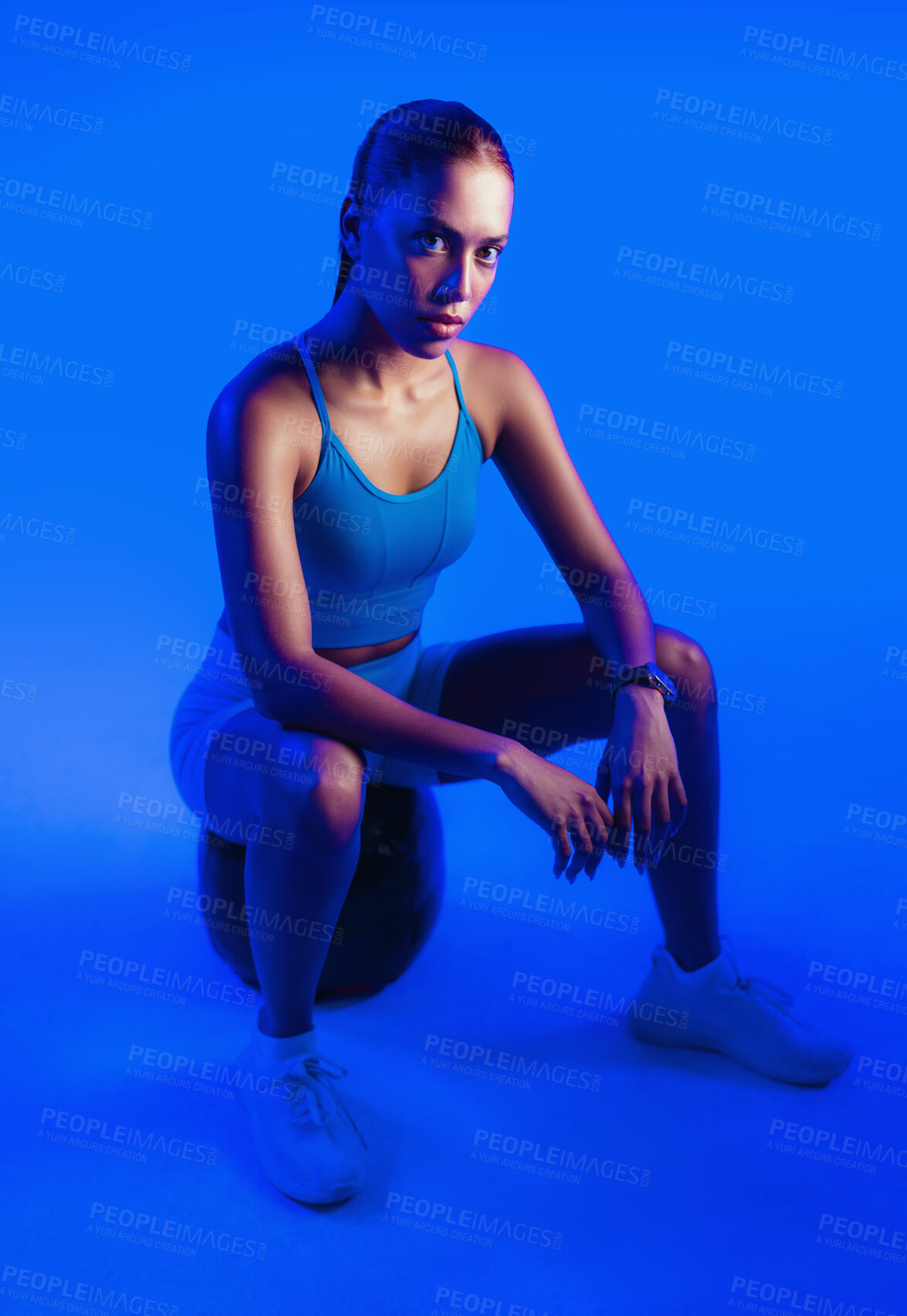 Buy stock photo Woman, exercise and medicine ball in studio with confidence, serious and portrait on blue background. Person, balance and training with pride, fitness or muscle development for wellness in Mexico