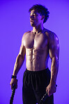 Man, battle rope and exhausted in studio for training, muscle or thinking with break on purple background. Person, tired and sweat with workout, exercise and cord with perspective for cardio wellness