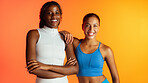 Women, friends and portrait in studio for fitness, bonding and pride with space on orange background. People, smile and solidarity for exercise club, wellness and support with partnership for gym