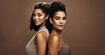 Portrait, skincare and women with smile in studio, natural beauty and self care together for wellness. Dermatology, friends and happy people with support for glowing skin, space and brown background