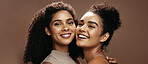Portrait, women and happy in studio with skincare, bonding together and makeup for beauty aesthetic. Friends, smile and confident with glowing skin, cosmetics and dermatology on brown background.