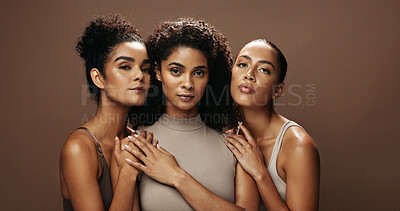 Buy stock photo Confident, women and friends with makeup in studio for beauty, natural glow and inclusion. Portrait, people and empowerment with banner, facial cosmetics and support for aesthetic on brown background