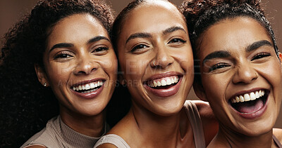 Buy stock photo Smile, women and friends with makeup in studio for beauty, natural glow and inclusion. Portrait, people and laughing with funny joke, facial cosmetics and makeover for aesthetic on brown background