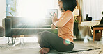 Meditation, prayer hands and woman in home for calm, zen or mindfulness in morning in living room. Wellness, flare and female person with yoga exercise for health, self care or relax in apartment.