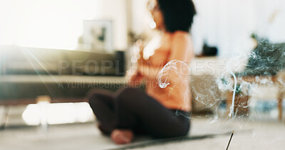 Buy stock photo Incense, meditate and woman in home lounge for wellness, self care and lotus for zen. Female person, yoga and smoke for aromatherapy to relax, meditation and calm in house with fragrance or scent