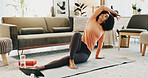 Woman, yoga and fitness in home with tablet, online class and stretching for holistic health on floor. Zen, person and side bend pose in living room with tech, pilates and website for video tutorial.