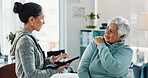 Old woman, physiotherapist and tablet with shoulder pain at clinic in consultation, explain and injury. People, healthcare professional and tech with notes, discussion and rehabilitation for recovery