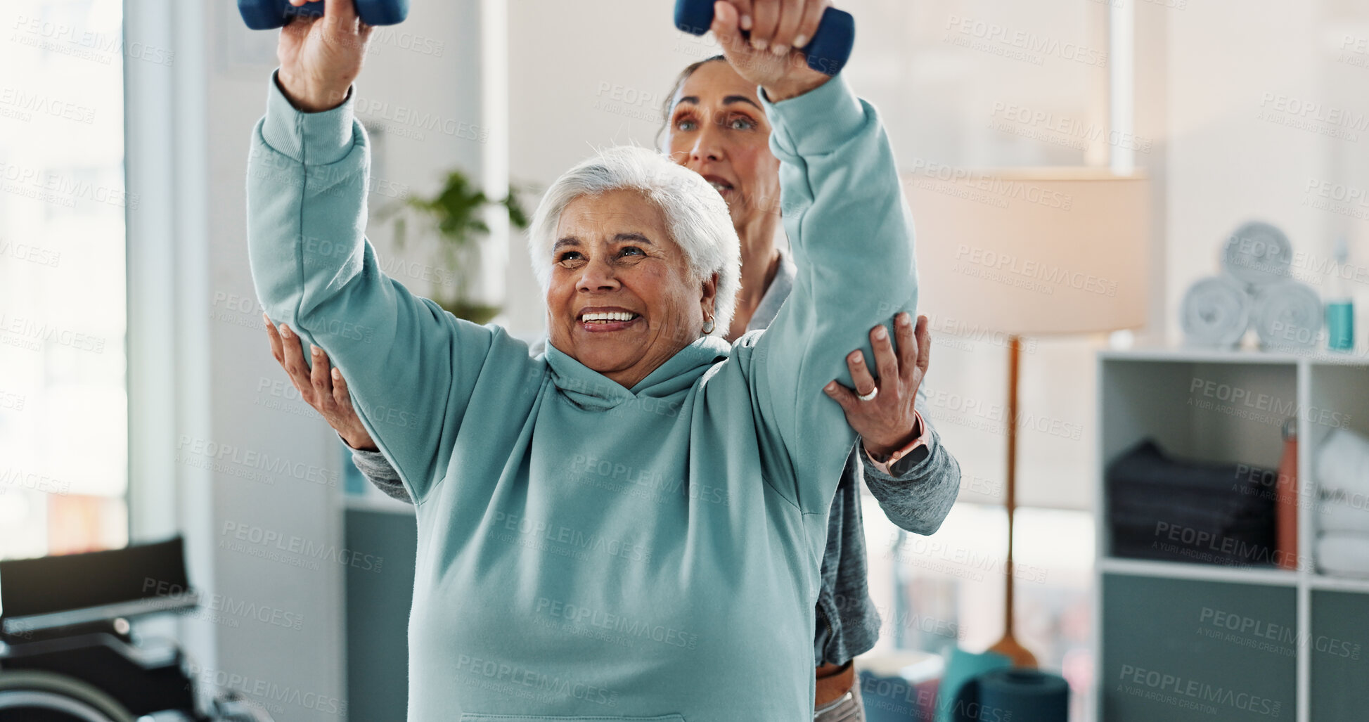 Buy stock photo Old woman, physiotherapist and smile with dumbbells at clinic for exercise, support or recovery for injury. People, healthcare professional and happy with help, strength training and rehabilitation