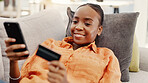 Black woman, relax and phone with credit card in home for ecommerce, fintech and transaction. Happy, person and mobile for online shopping, easy payment and bank information of purchase subscription