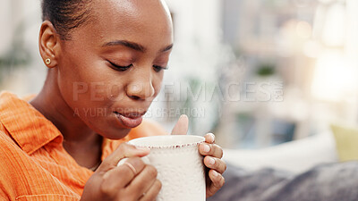 Buy stock photo Black woman, coffee and blow steam on sofa with aroma, scent and relax with hot beverage in home. Person, tea cup and warm drink with latte, cappuccino or chilling on couch for break at apartment