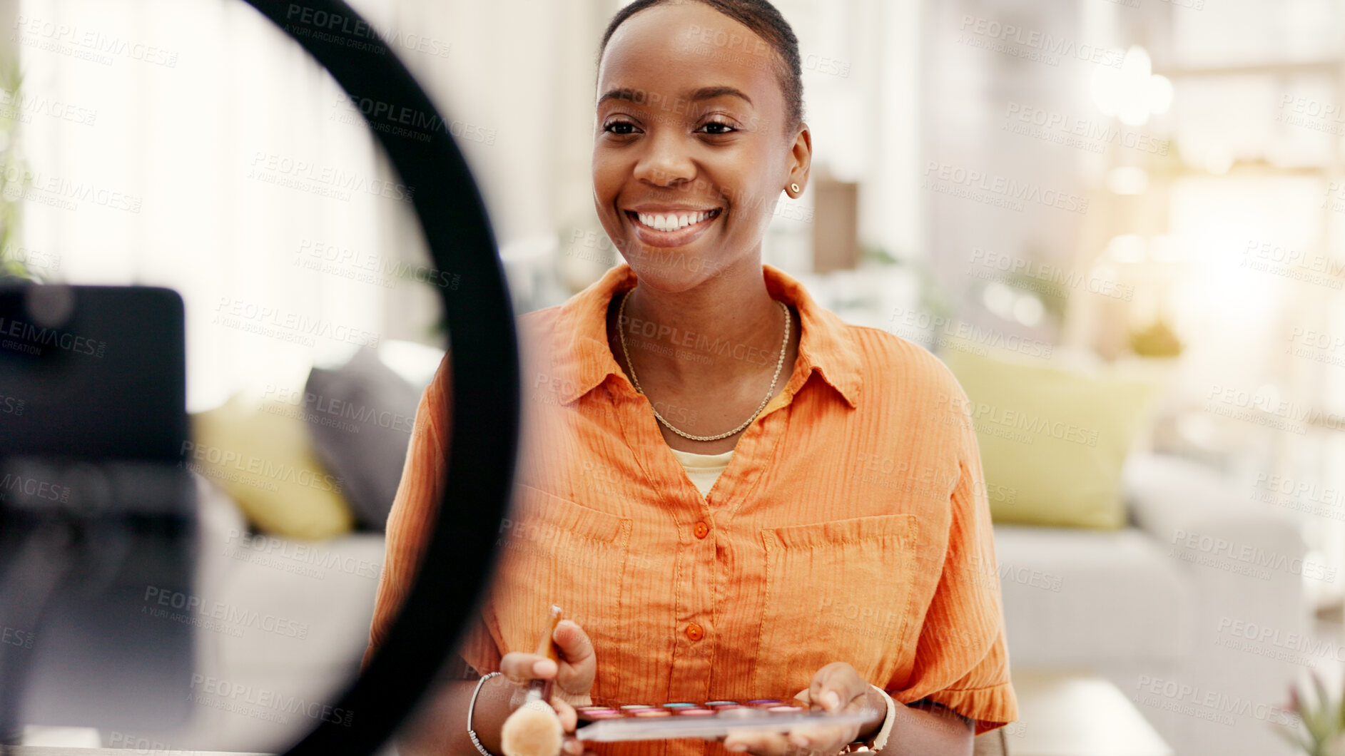 Buy stock photo Happy woman, influencer and makeup tutorial on phone, ring light or talking with audience on website. Content creation, mobile and black person with eyeshadow palette, social media and video in home