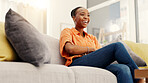 Happy woman, watching tv and chilling on couch in house, low angle and subscription for funny movies. Laughing, black person and streaming comedy film on sofa, home and relax with humor on weekend