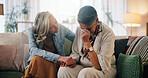 Woman, crying and holding hands in home with friends, support or compassion for healing from grief. Mature, people and empathy in living room with sadness, understanding or comfort to process trauma.