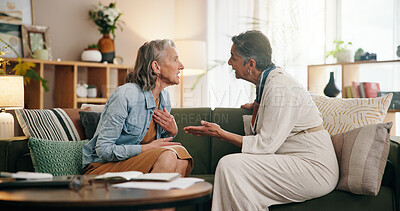 Buy stock photo Lesbian couple, fight and argument on sofa with stress, retirement or bad credit score at home. Senior women, partner and conflict with financial crisis, mistake and frustrated on couch at apartment