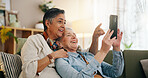 Phone, mature and lesbian couple in house with conversation, social media video and bonding together. Happy, lgbt people and point on sofa with tech, relationship and discussion for online blog post.