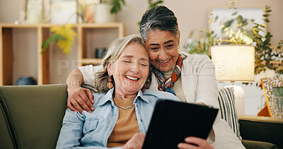 Buy stock photo Tablet, mature and lesbian couple in home with laugh, comedy film and bonding together on weekend. Happy, lgbt people and relax in living room with digital tech, relationship or humor for funny movie