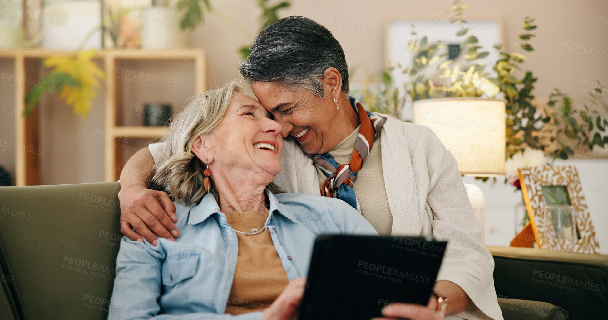 Buy stock photo Tablet, mature and lesbian couple in house with love, connection and bonding together on weekend. Happy, lgbt people and relax in living room with digital tech, relationship commitment and support.