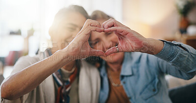 Buy stock photo Lesbian, smile or couple in house with heart hands, commitment or bonding together on weekend break. LGBTQ, flare or mature women with gesture, connection or romantic moment in healthy relationship.