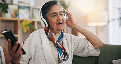 Buy stock photo Old woman, headphones and happy on sofa with singing in home with phone, streaming and listen to music. Senior person, smartphone and smile with sound, audio subscription or mobile app in retirement