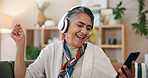 Old woman, headphones and happy on sofa with phone in home with dance, streaming and listen to music. Senior person, smartphone and smile with sound, audio subscription or mobile app in retirement