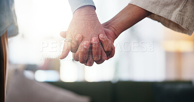 Buy stock photo Closeup, holding hands and couple in home, comfort and relationship with kindness, trust and love. Apartment, hope or people in living room, gratitude and support for compassion, sympathy and empathy