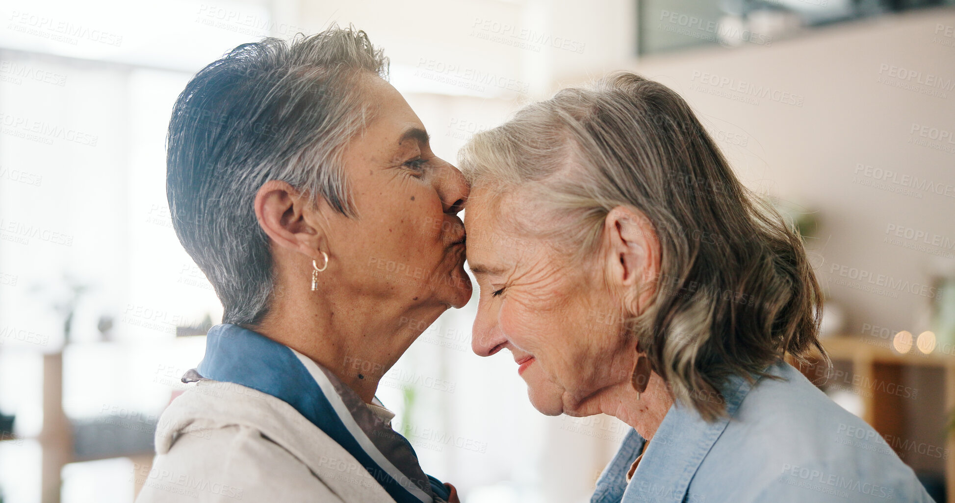 Buy stock photo Lesbian, forehead kiss or couple in home with love, commitment or bonding together on weekend break. LGBTQ, care or mature women with affection, connection or romantic moment in healthy relationship.