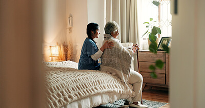 Buy stock photo Caregiver, relax and old woman in nursing home with walking stick, support and bonding together on bed. Nurse, help and elderly person in with disability, checkup and wellness in retirement center.