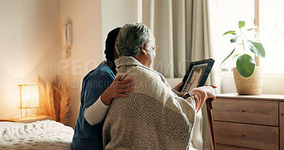 Buy stock photo Caregiver, support and old woman in nursing home with picture frame, bonding or memories of marriage. Back, senior person and nurse in retirement center with photo, comfort or nostalgia for loved one