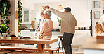 Dancing, happy and senior couple in kitchen, romance and retirement fun for anniversary celebration. Home, bonding and elderly people with support for healthy relationship, marriage or music for spin