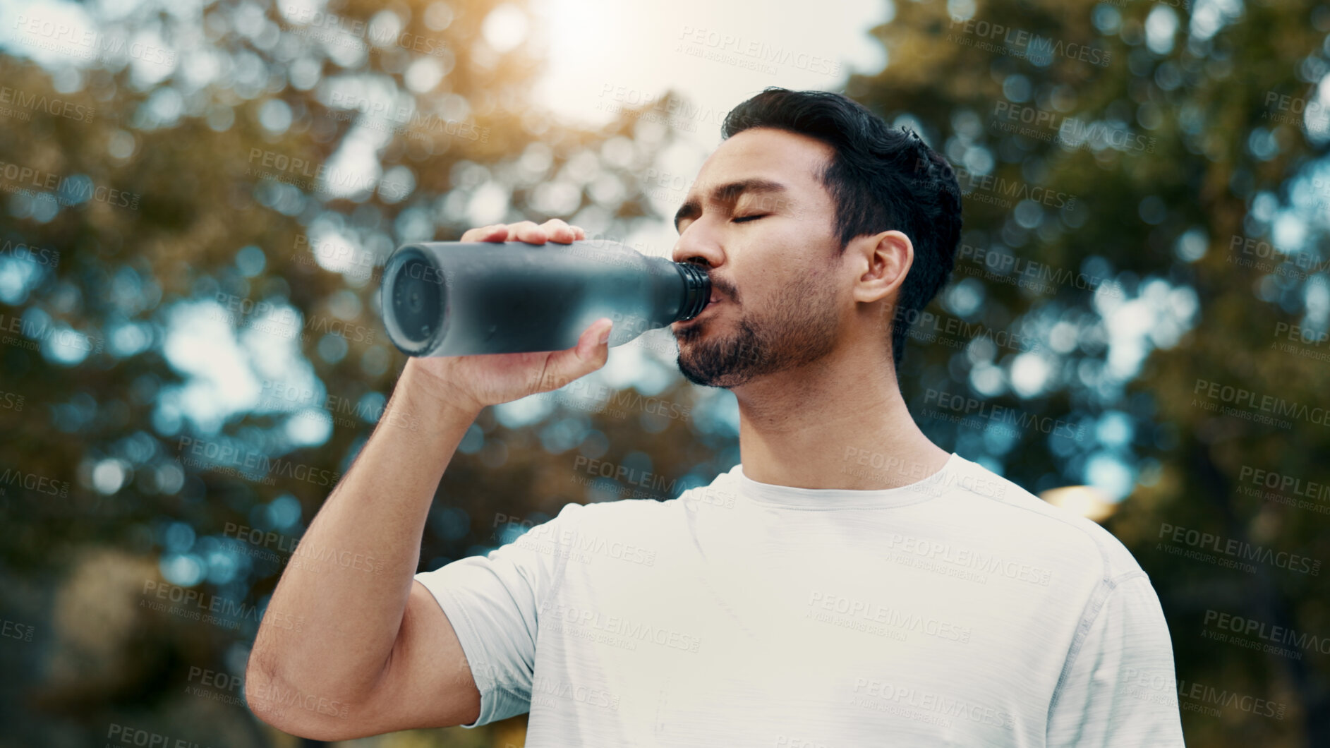 Buy stock photo Drinking water, fitness and man in nature, rest and hydration with workout, electrolytes and break. Outdoor, athlete and person with bottle, thirsty and nutrition with exercise for health benefits