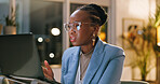Confused, black woman and laptop in office at night for bad news, online criticism and article error. Frustrated, person and pc with negative feedback, false source and deadline fail for publication