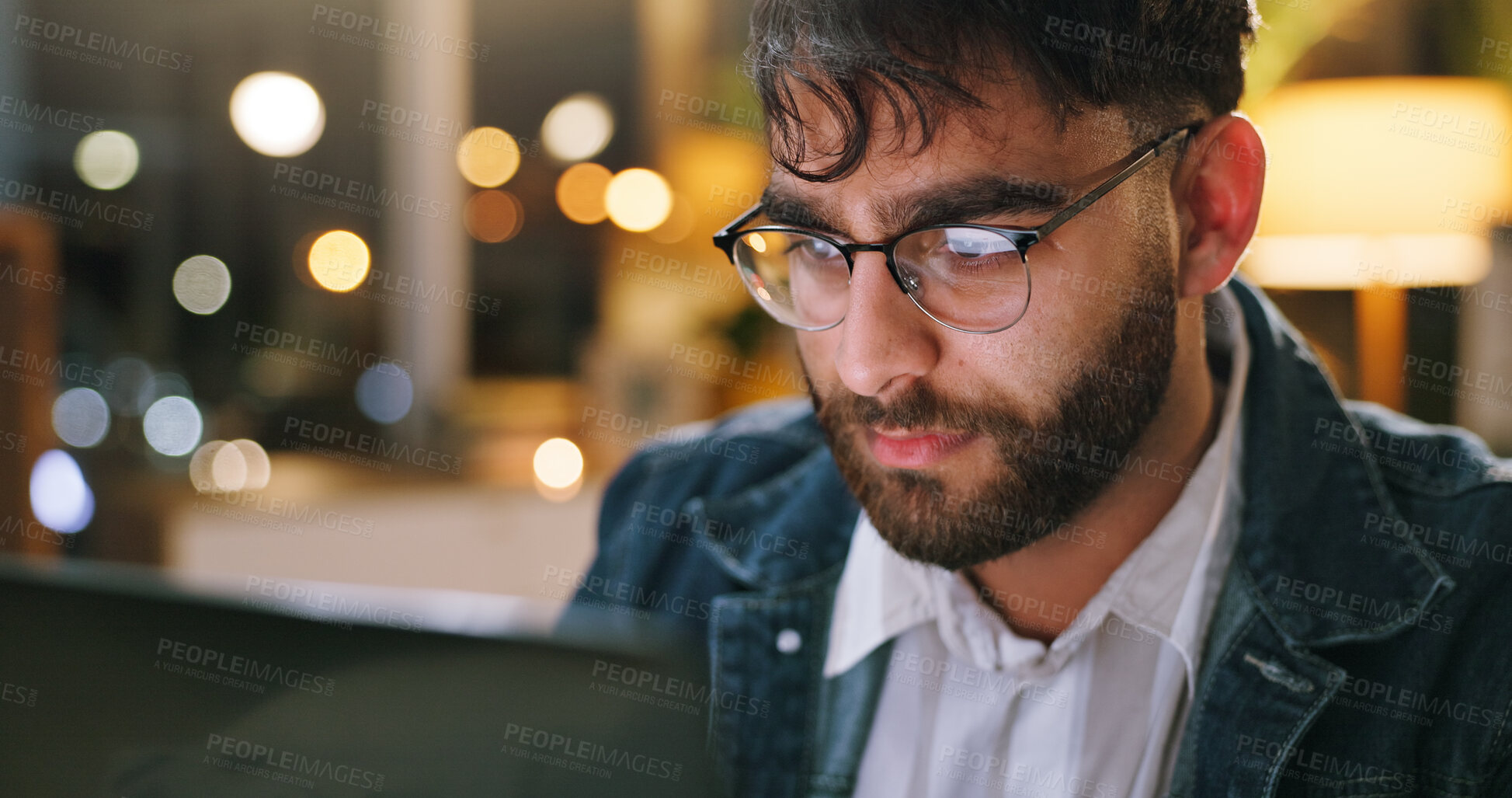 Buy stock photo Night, glasses or man in office with laptop, draft edit or fact checking in article review. Bokeh, specs or journalist in newsroom with technology, proofreading or industry research in overtime.